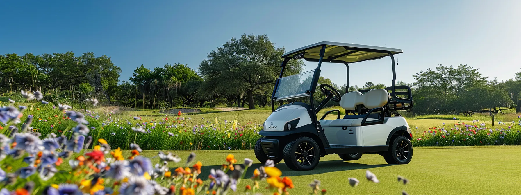 A Vibrant Electric Golf Cart Glides Effortlessly Along A Sun-Dappled Green Fairway, Surrounded By Lush Greenery And Bright Wildflowers Under A Clear Blue Sky.